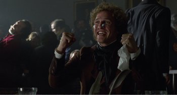 Movie still from “Amistad” (1997), directed by Steven Spielberg – A man in a brown jacket holding a piece of paper in his hand; Close Up shot, Low angle