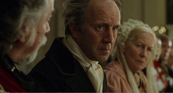 Movie still from “Amistad” (1997), directed by Steven Spielberg – An old man with a white beard is looking at the camera; Close Up shot, Over the shoulder angle