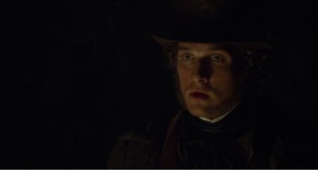 Movie still from “Amistad” (1997), directed by Steven Spielberg – A person wearing a hat in the dark; Close Up shot, Over the shoulder angle