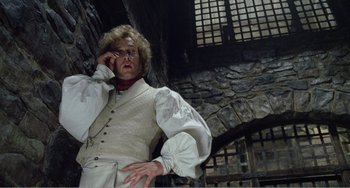 Movie still from “Amistad” (1997), directed by Steven Spielberg – An older woman wearing a white shirt and a white vest; Medium shot, Low angle