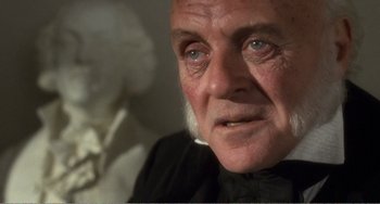 Movie still from “Amistad” (1997), directed by Steven Spielberg – An old man with a black shirt and a white beard; Close Up shot, Over the shoulder angle