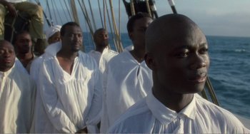 Movie still from “Amistad” (1997), directed by Steven Spielberg – A group of men standing next to each other on top of a boat; Close Up shot, High angle