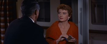 Movie still from “An Affair to Remember” (1957), directed by Leo McCarey – A woman in a red dress talking to a man in a black suit; Close Up shot, Over the shoulder angle