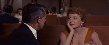 Movie still from “An Affair to Remember” (1957), directed by Leo McCarey – An older man sitting next to an older woman in a restaurant; Close Up shot, Over the shoulder angle