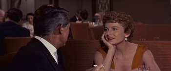 Movie still from “An Affair to Remember” (1957), directed by Leo McCarey – An older man sitting next to an older woman in a restaurant; Close Up shot, Over the shoulder angle