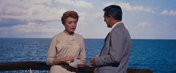 Movie still from “An Affair to Remember” (1957), directed by Leo McCarey – A man and a woman standing next to a body of water; Medium shot, Over the shoulder angle
