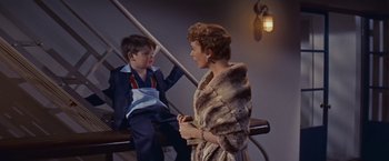 Movie still from “An Affair to Remember” (1957), directed by Leo McCarey – An older woman and a young boy are talking to each other; Medium shot, High angle