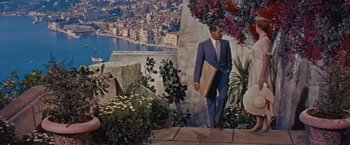 Movie still from “An Affair to Remember” (1957), directed by Leo McCarey – A man in a suit and tie holding a briefcase walking down steps; Wide shot, High angle