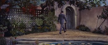 Movie still from “An Affair to Remember” (1957), directed by Leo McCarey – A man in a suit walking down the street; Wide shot, Low angle