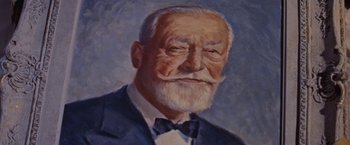Movie still from “An Affair to Remember” (1957), directed by Leo McCarey – An old man with a beard and a mustache wearing a suit and bow tie; Close Up shot, Low angle