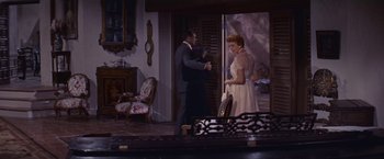 Movie still from “An Affair to Remember” (1957), directed by Leo McCarey – A man and a woman are standing in front of a mirror; Wide shot, High angle