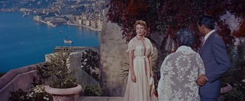 Movie still from “An Affair to Remember” (1957), directed by Leo McCarey – A woman in a white dress standing in front of a lake; Wide shot, Low angle