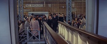 Movie still from “An Affair to Remember” (1957), directed by Leo McCarey – A group of people standing next to each other on a bridge; Wide shot, High angle