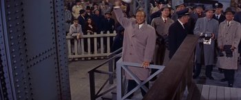 Movie still from “An Affair to Remember” (1957), directed by Leo McCarey – A man in a purple coat is holding a ball in the air; Medium shot, Low angle