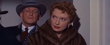 Movie still from “An Affair to Remember” (1957), directed by Leo McCarey – An older woman wearing a fur coat with a man standing next to her; Close Up shot, Over the shoulder angle