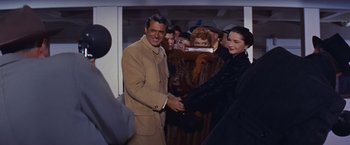 Movie still from “An Affair to Remember” (1957), directed by Leo McCarey – A man and a woman shaking hands in a crowd; Medium shot, High angle