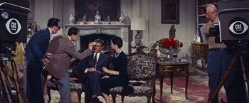 Movie still from “An Affair to Remember” (1957), directed by Leo McCarey – A man and a woman sitting in a living room; Medium shot, High angle