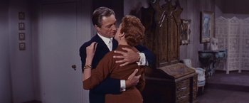 Movie still from “An Affair to Remember” (1957), directed by Leo McCarey – A man and a woman hugging each other in front of a mirror; Medium shot, High angle