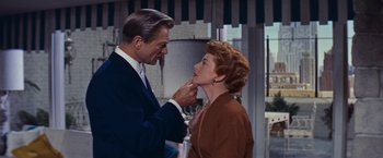 Movie still from “An Affair to Remember” (1957), directed by Leo McCarey – An older man putting lipstick on an older woman's face; Close Up shot, Low angle