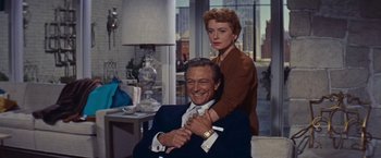 Movie still from “An Affair to Remember” (1957), directed by Leo McCarey – A man and a woman are posing for a picture; Medium shot, Low angle