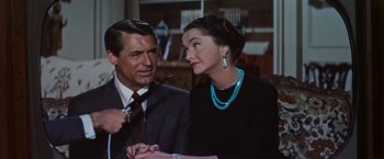 Movie still from “An Affair to Remember” (1957), directed by Leo McCarey – An older man and a younger woman wearing jewelry; Close Up shot, Over the shoulder angle