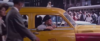 Movie still from “An Affair to Remember” (1957), directed by Leo McCarey – An older man sitting in the driver's seat of a yellow taxi cab; Medium shot, Low angle