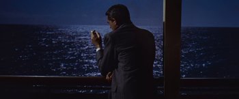 Movie still from “An Affair to Remember” (1957), directed by Leo McCarey – A man standing on a balcony looking out at the ocean; Medium shot, High angle