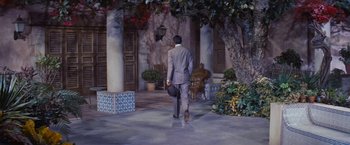 Movie still from “An Affair to Remember” (1957), directed by Leo McCarey – A man in a gray suit walking down the street; Wide shot, High angle