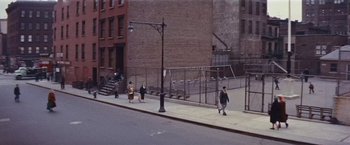 Movie still from “An Affair to Remember” (1957), directed by Leo McCarey – A group of people walking down a sidewalk near a building; Extreme Wide shot, High angle
