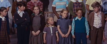 Movie still from “An Affair to Remember” (1957), directed by Leo McCarey – A group of children standing next to each other in dresses; Close Up shot, Low angle