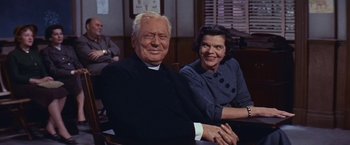 Movie still from “An Affair to Remember” (1957), directed by Leo McCarey – An older man sitting next to an older woman; Medium shot, Low angle
