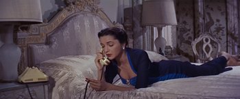 Movie still from “An Affair to Remember” (1957), directed by Leo McCarey – A woman laying on a bed talking on a phone; Medium shot, High angle