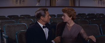 Movie still from “An Affair to Remember” (1957), directed by Leo McCarey – A man and a woman in formal wear in a theater; Medium shot, Low angle