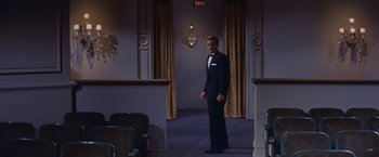 Movie still from “An Affair to Remember” (1957), directed by Leo McCarey – A man in a tuxedo standing in a room; Wide shot, High angle