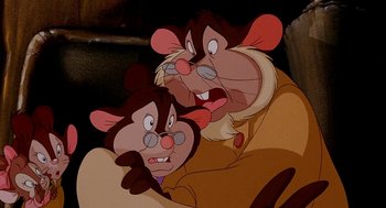 Movie still from “An American Tail: Fievel Goes West” (1991), directed by Simon Wells – A couple of cartoon mice are sitting next to each other; Close Up shot, High angle