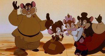 Movie still from “An American Tail: Fievel Goes West” (1991), directed by Simon Wells – A group of people standing next to each other on the ground; Medium shot, High angle