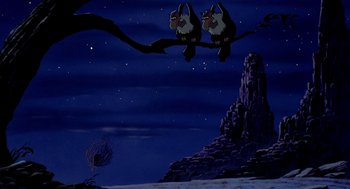 Movie still from “An American Tail: Fievel Goes West” (1991), directed by Simon Wells – Two birds sitting on top of a tree branch in the night sky; Wide shot, Low angle