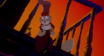 Movie still from “An American Tail: Fievel Goes West” (1991), directed by Simon Wells – A cat sitting on top of a wooden railing in front of an orange sky; Medium shot, Over the shoulder angle