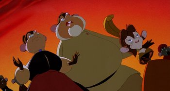 Movie still from “An American Tail: Fievel Goes West” (1991), directed by Simon Wells – A group of people standing next to each other in front of an orange background; Close Up shot, Low angle