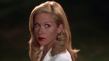 Movie still from “Anchorman: The Legend of Ron Burgundy” (2004), directed by Adam McKay – A woman with blonde hair and red lipstick looking to her left; Close Up shot, Over the shoulder angle