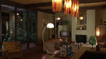 Movie still from “Anchorman: The Legend of Ron Burgundy” (2004), directed by Adam McKay – A living room filled with furniture next to a fire place; Wide shot, Low angle