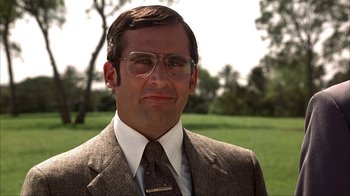 Movie still from “Anchorman: The Legend of Ron Burgundy” (2004), directed by Adam McKay – A person wearing a suit and tie; Close Up shot, Low angle