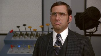 Movie still from “Anchorman: The Legend of Ron Burgundy” (2004), directed by Adam McKay – A person wearing a suit and tie; Close Up shot, Over the shoulder angle