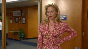 Movie still from “Anchorman: The Legend of Ron Burgundy” (2004), directed by Adam McKay – A woman in a pink dress standing next to a door; Medium shot, Over the shoulder angle