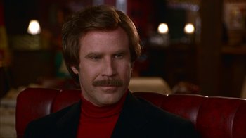 Movie still from “Anchorman: The Legend of Ron Burgundy” (2004), directed by Adam McKay – A person wearing a suit and tie; Close Up shot, Low angle