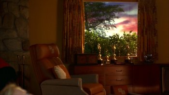 Movie still from “Anchorman: The Legend of Ron Burgundy” (2004), directed by Adam McKay – A living room with a chair , dresser and a window; Extreme Wide shot, Low angle
