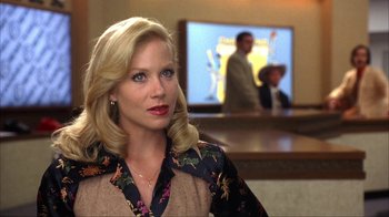 Movie still from “Anchorman: The Legend of Ron Burgundy” (2004), directed by Adam McKay – A woman with blonde hair and a floral blouse; Close Up shot, Over the shoulder angle
