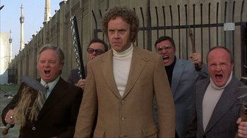 Movie still from “Anchorman: The Legend of Ron Burgundy” (2004), directed by Adam McKay – A group of men standing next to each other; Medium shot, Low angle