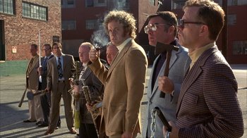 Movie still from “Anchorman: The Legend of Ron Burgundy” (2004), directed by Adam McKay – A group of men standing next to each other on a street; Wide shot, Low angle