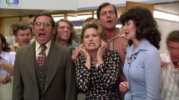 Movie still from “Anchorman: The Legend of Ron Burgundy” (2004), directed by Adam McKay – A group of people that are standing up; Medium shot, Low angle